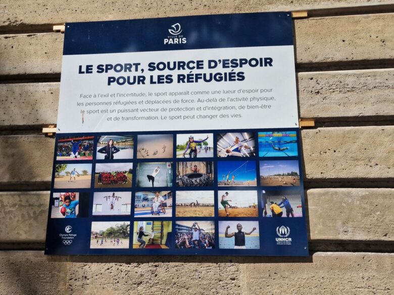 A sign reading “Faced with exile and uncertainty, sport is a beacon of hope for refugees and forcibly displaced people. Beyond physical activity, sport is a powerful vector for protection and integration, for wellbeing and for transformation. Sports can change lives.”