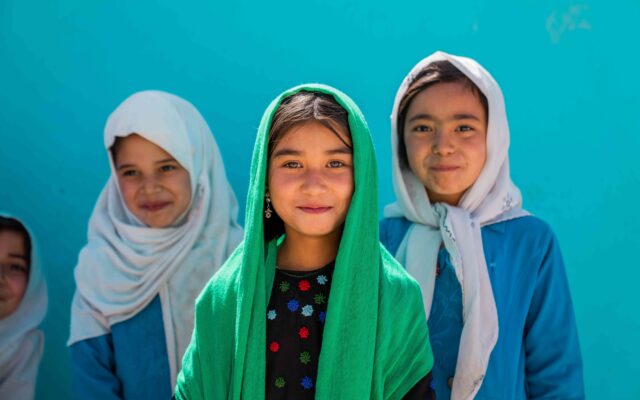 Three young Afghan girls in front of Dasht-e-Essa Khan middle school, in Dasht-e-Essa Khan village.