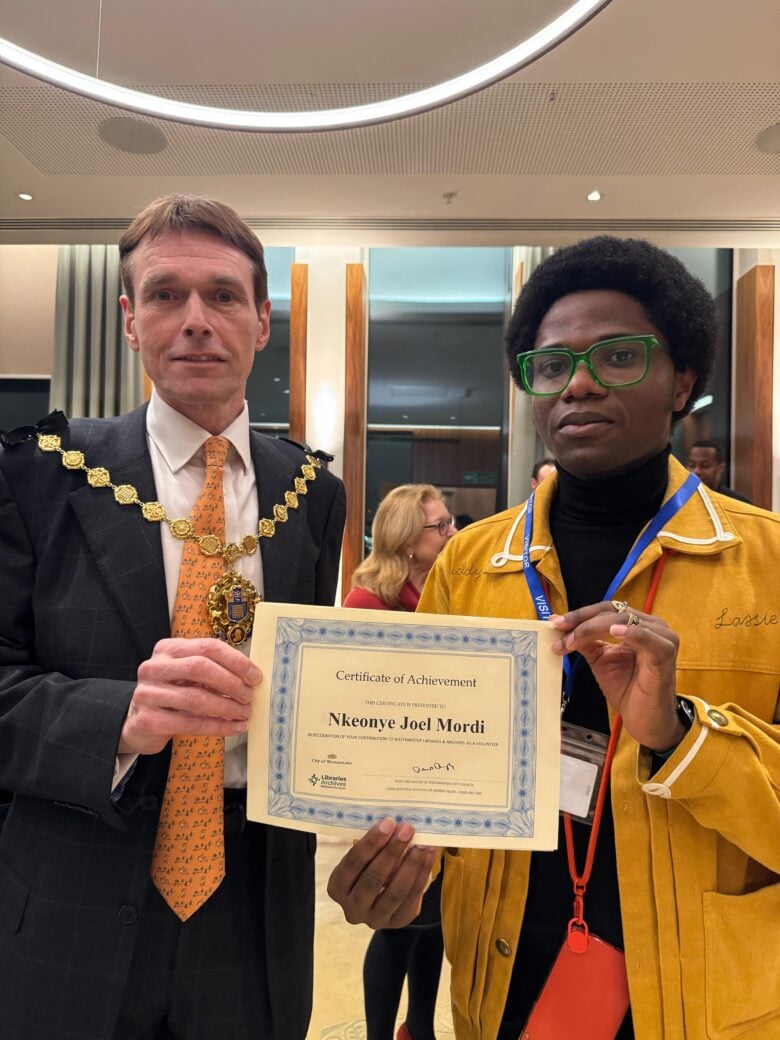 Joel receives a certificate from the Lord Mayor of London for his volunteering achievement. 